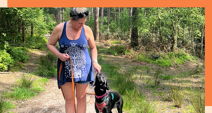 a dog trainer giving a dog a treat after success in a training session